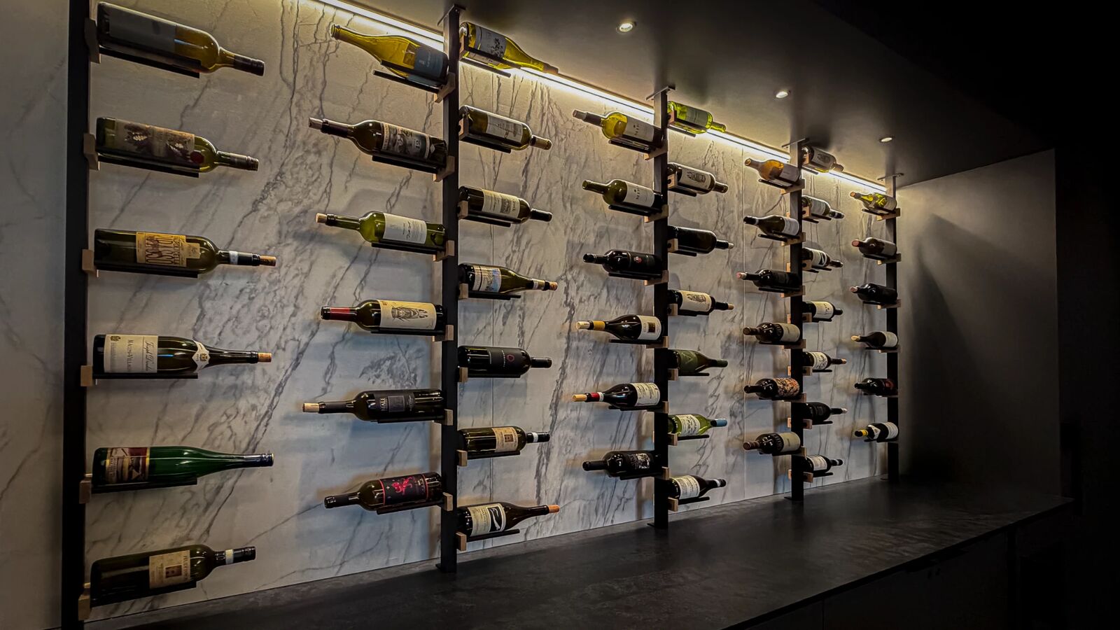 Backlit wine wall on white marble
